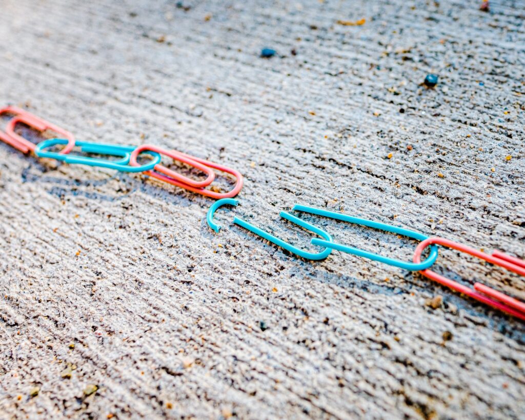 Broken paperclips representing an unequal division of property in a divorce