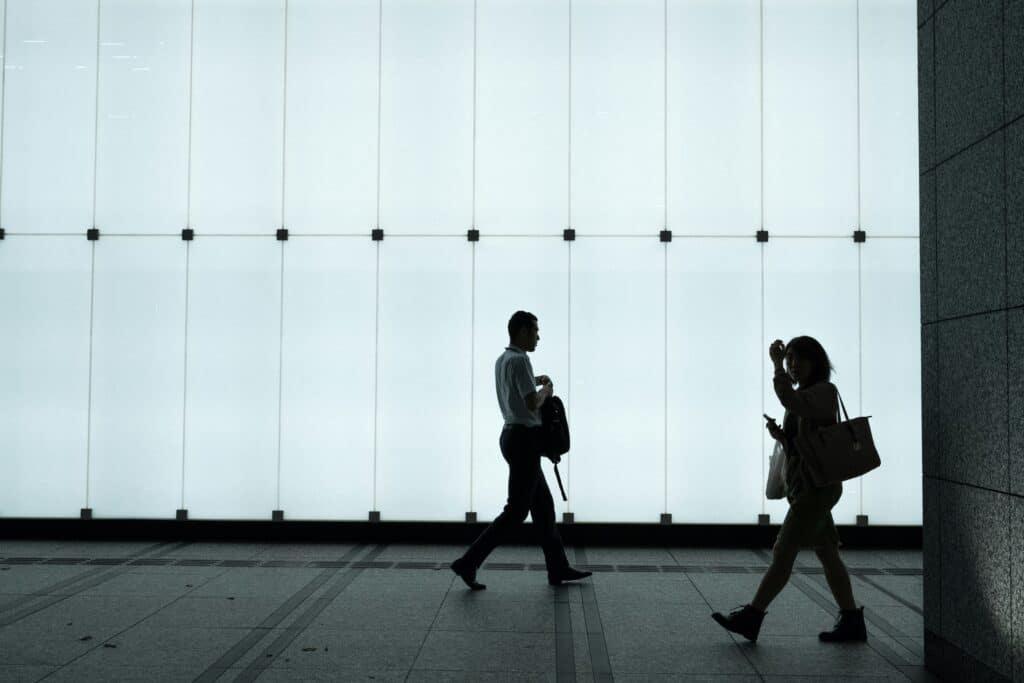 silhouette of two people walking
