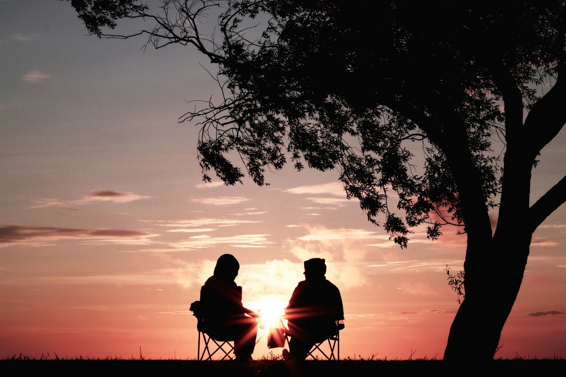 silhouette of two people talking