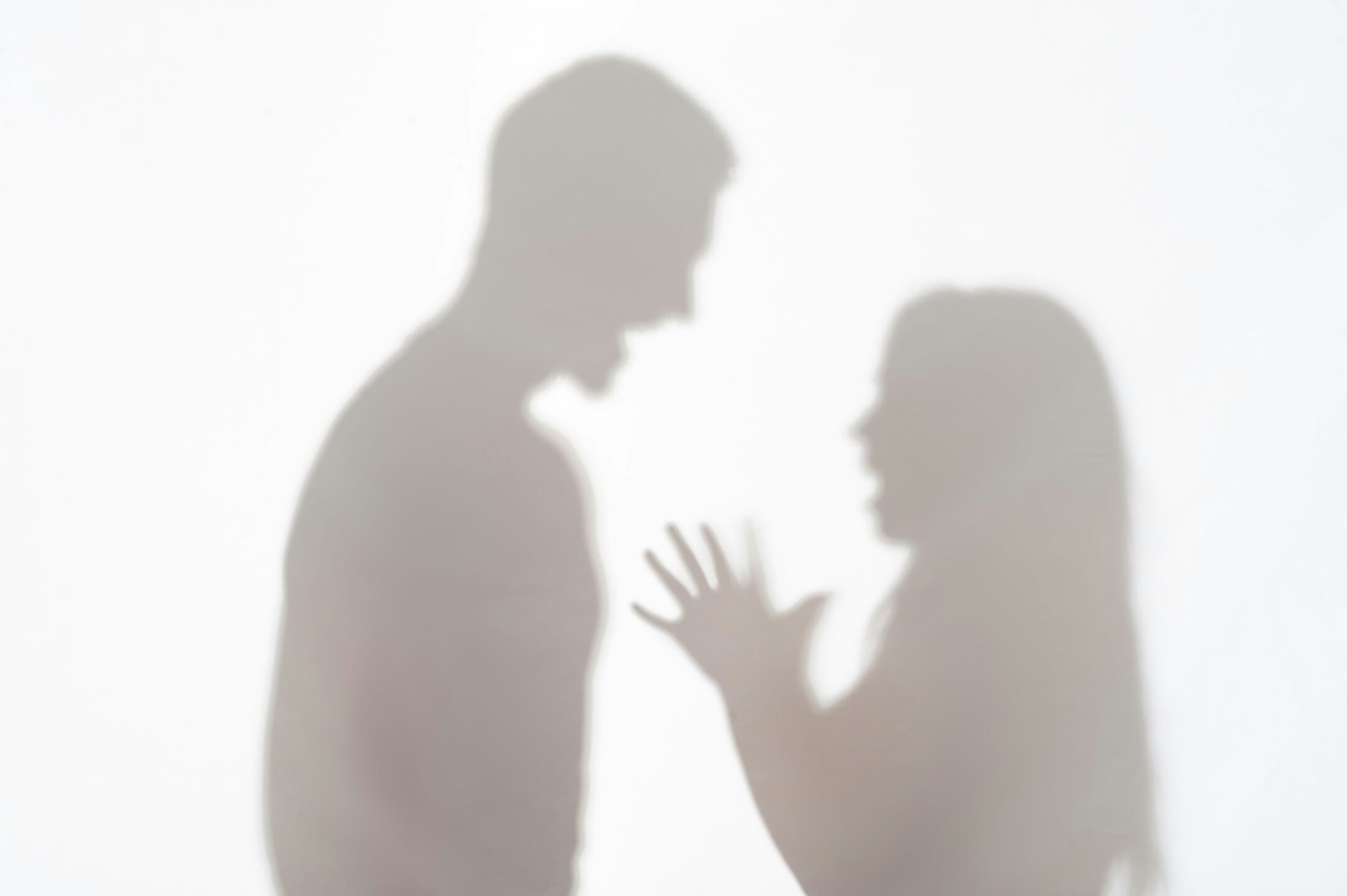 silhouette of people arguing representing divorce and the division of the family home