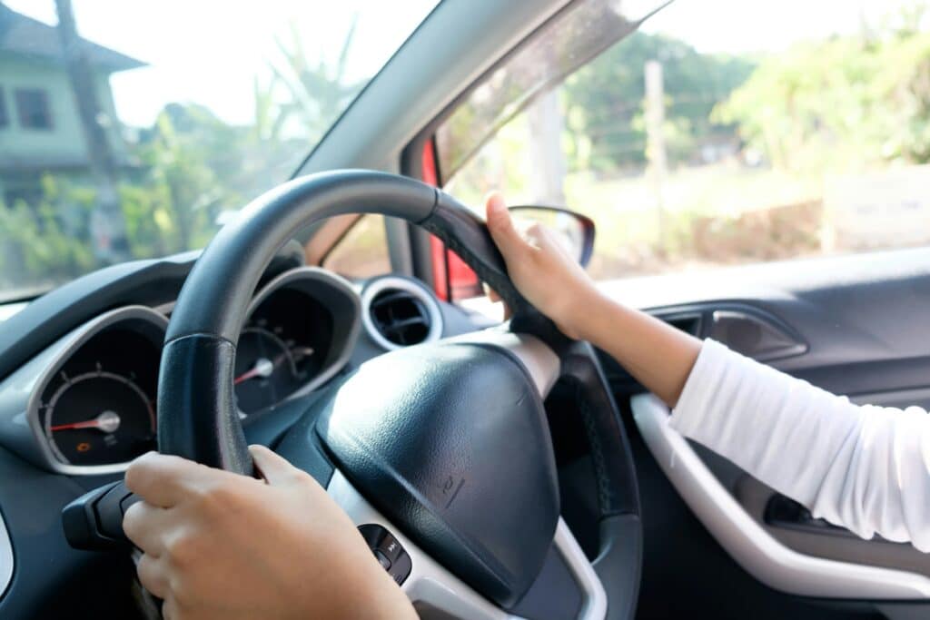 Person behind steering wheel representing how fault is determined in BC car accidents