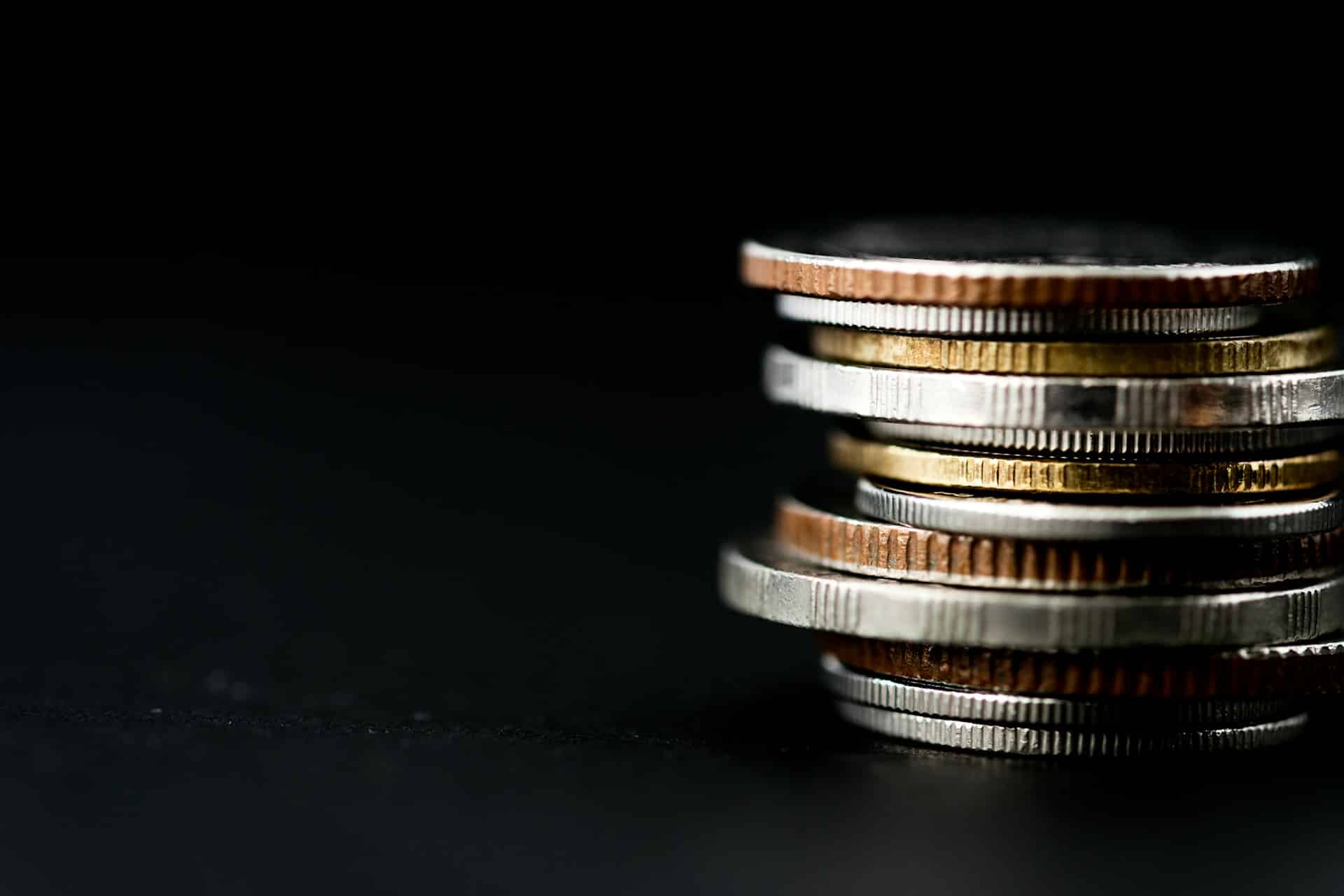 A stack of coins against a black background, representing child support disputes and income imputation