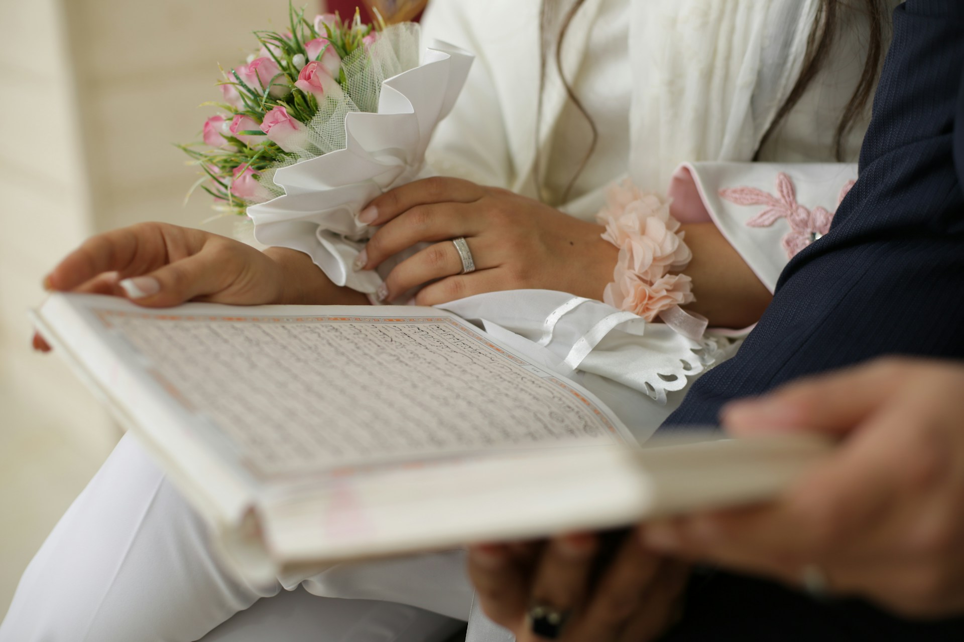 A newly married husband and wife reading the Quran, representing Islamic wedding agreements and their enforceability in BC family and estate law.