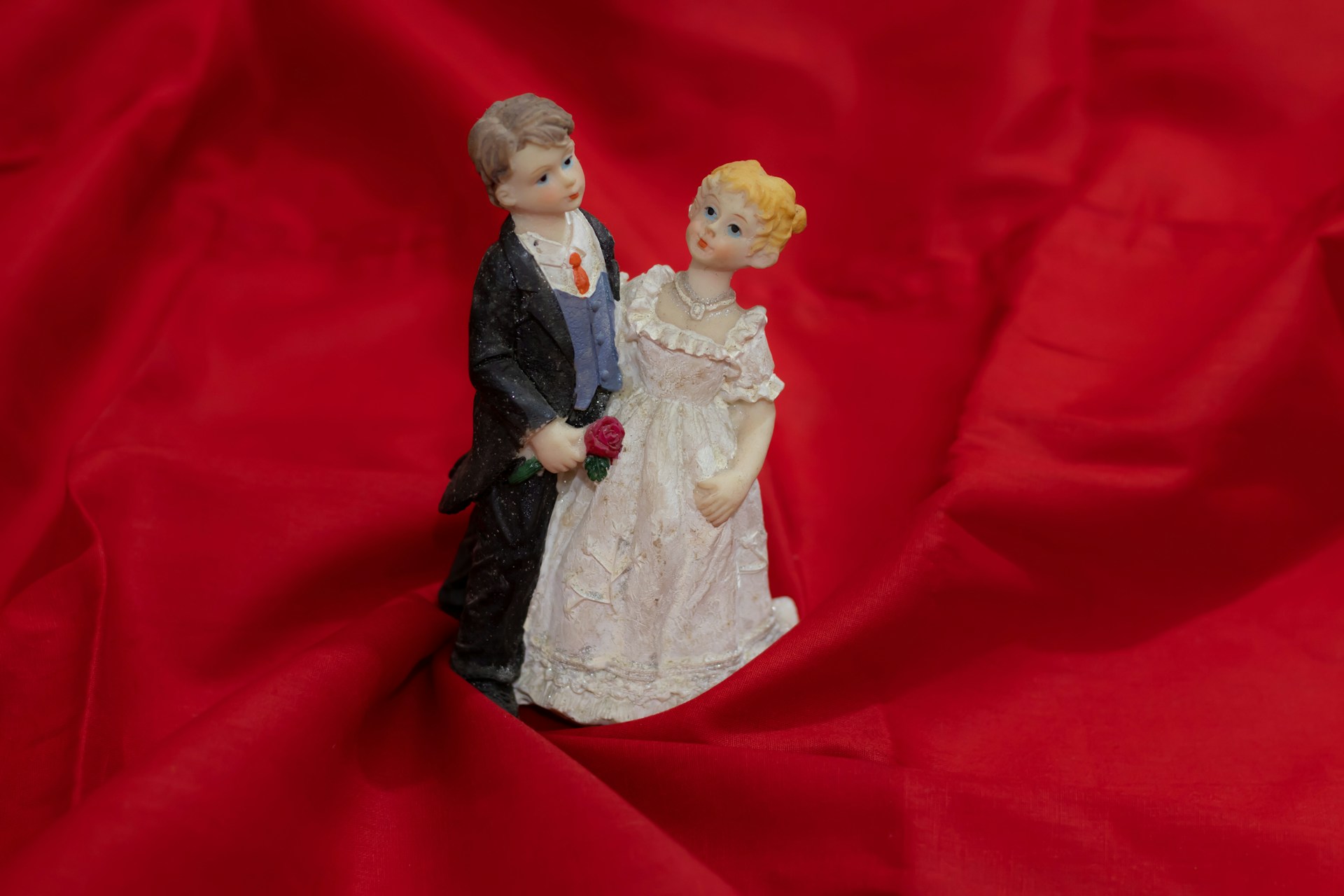 A bride and groom statue standing in the folds of red fabric, representing setting aside a separation agreement in BC.