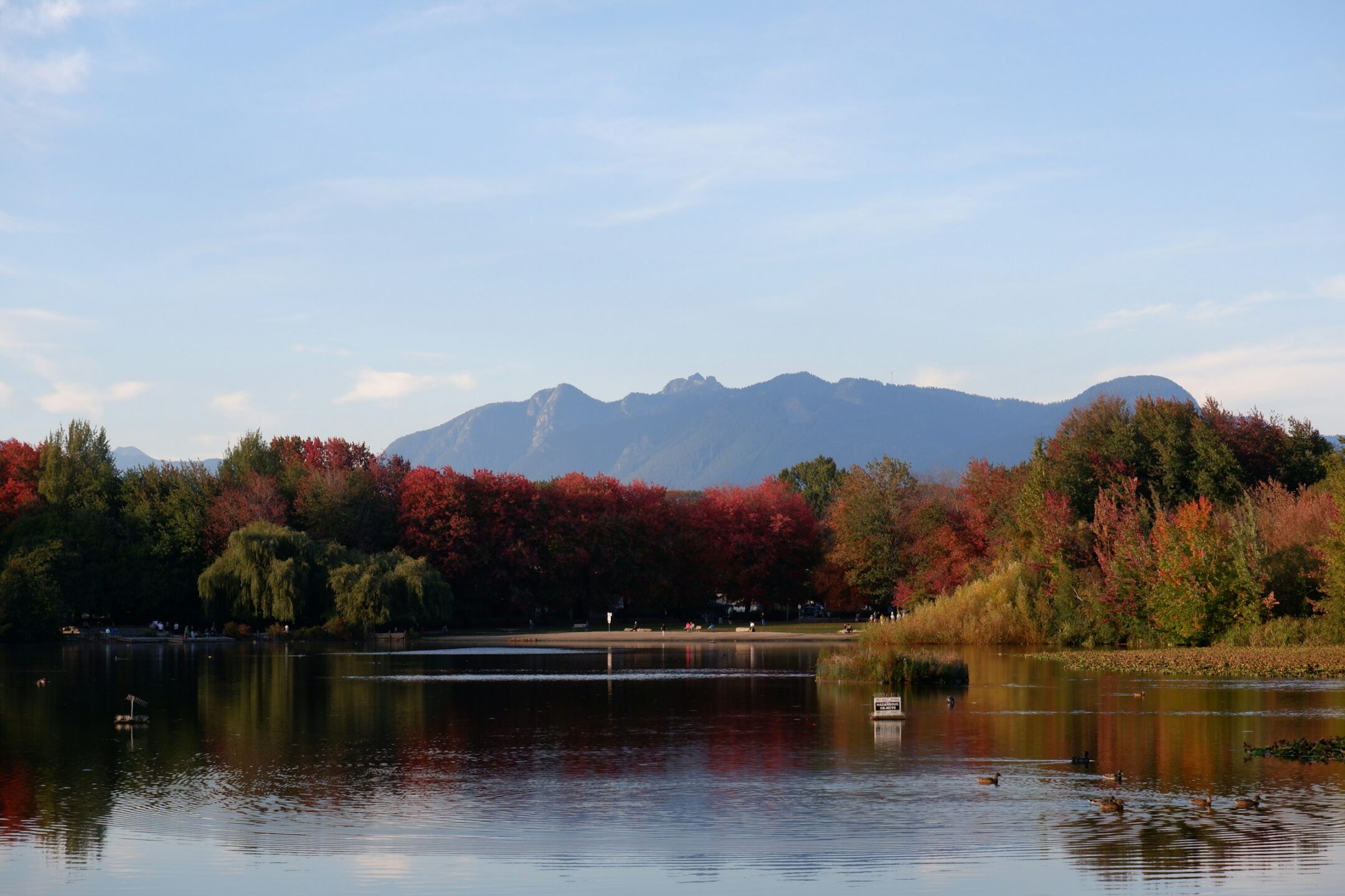 A beautiful mountainside lake in BC during fall foliage, representing waterfront property owner rights and riparian rights in Vancouver and across British Columbia, and the property dispute litigation services of Meridian Law Group.