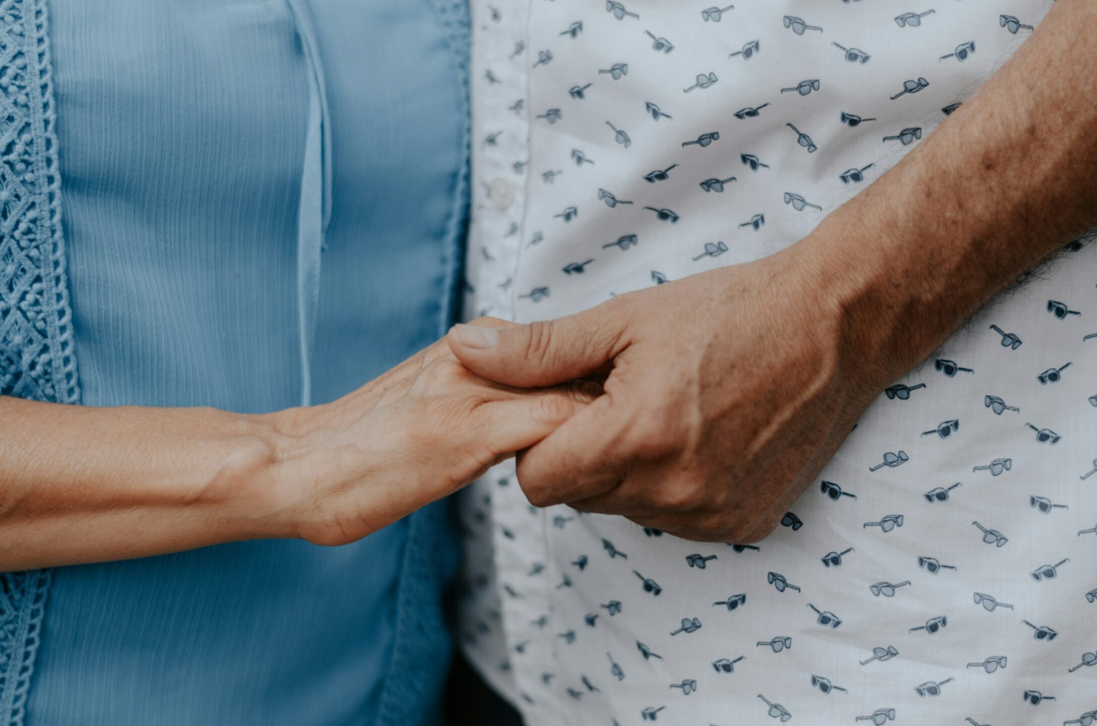 A younger person holding an older person's hand, representing committeeship disputes and committee removals, and the committeeship litgation services provided by Meridian Law Group in Vancouver and across British Columbia.