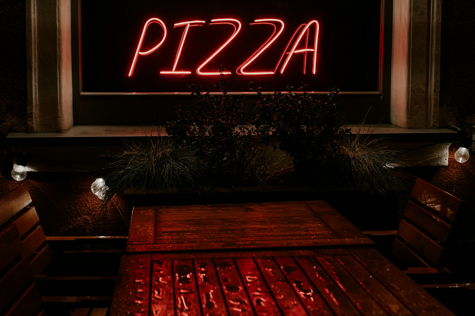 A neon pizza sign in a restaurant representing franchise disputes in British Columbia
