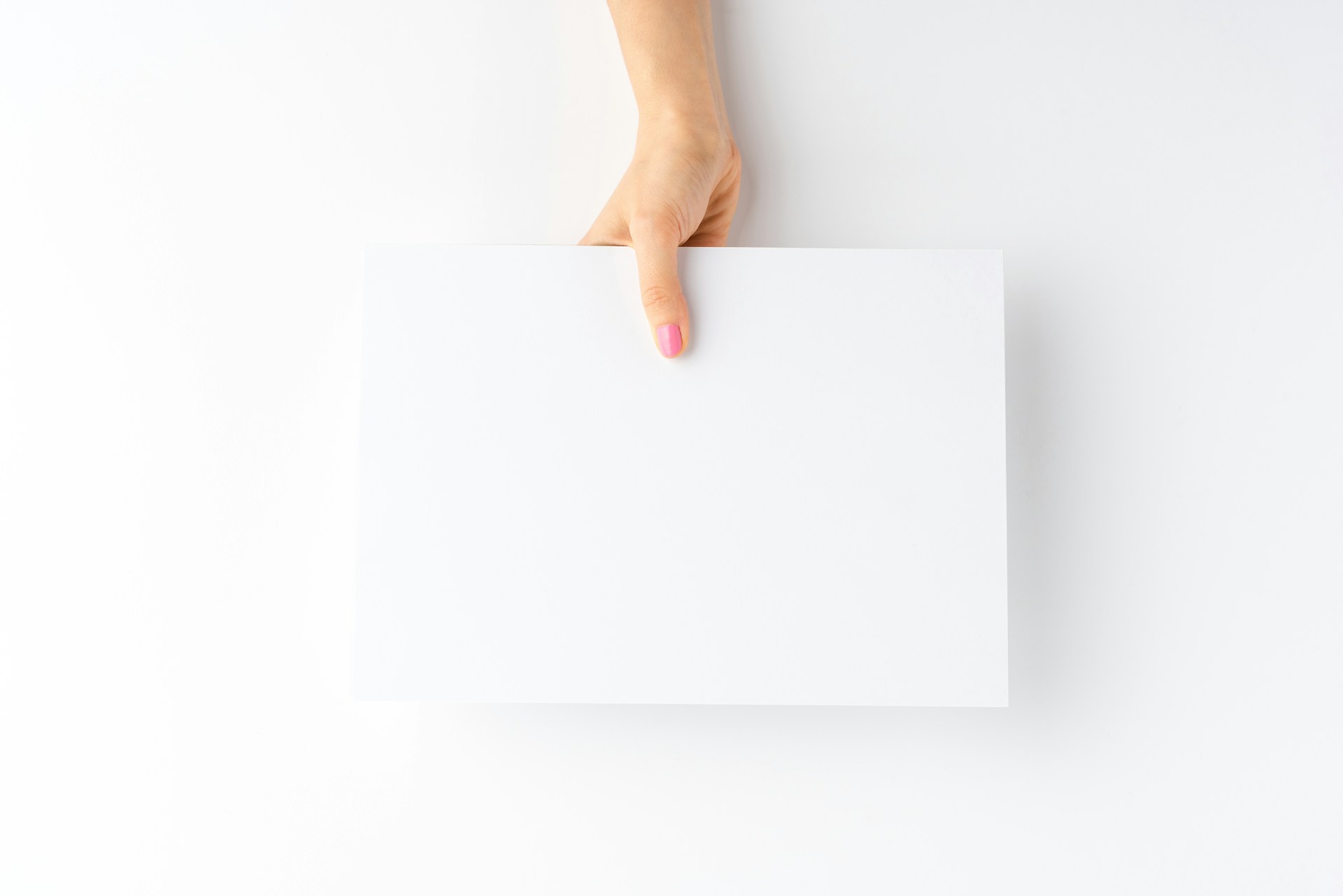 A woman holding a blank piece of paper representing phantom bids and fake offers in Vancouver real estate