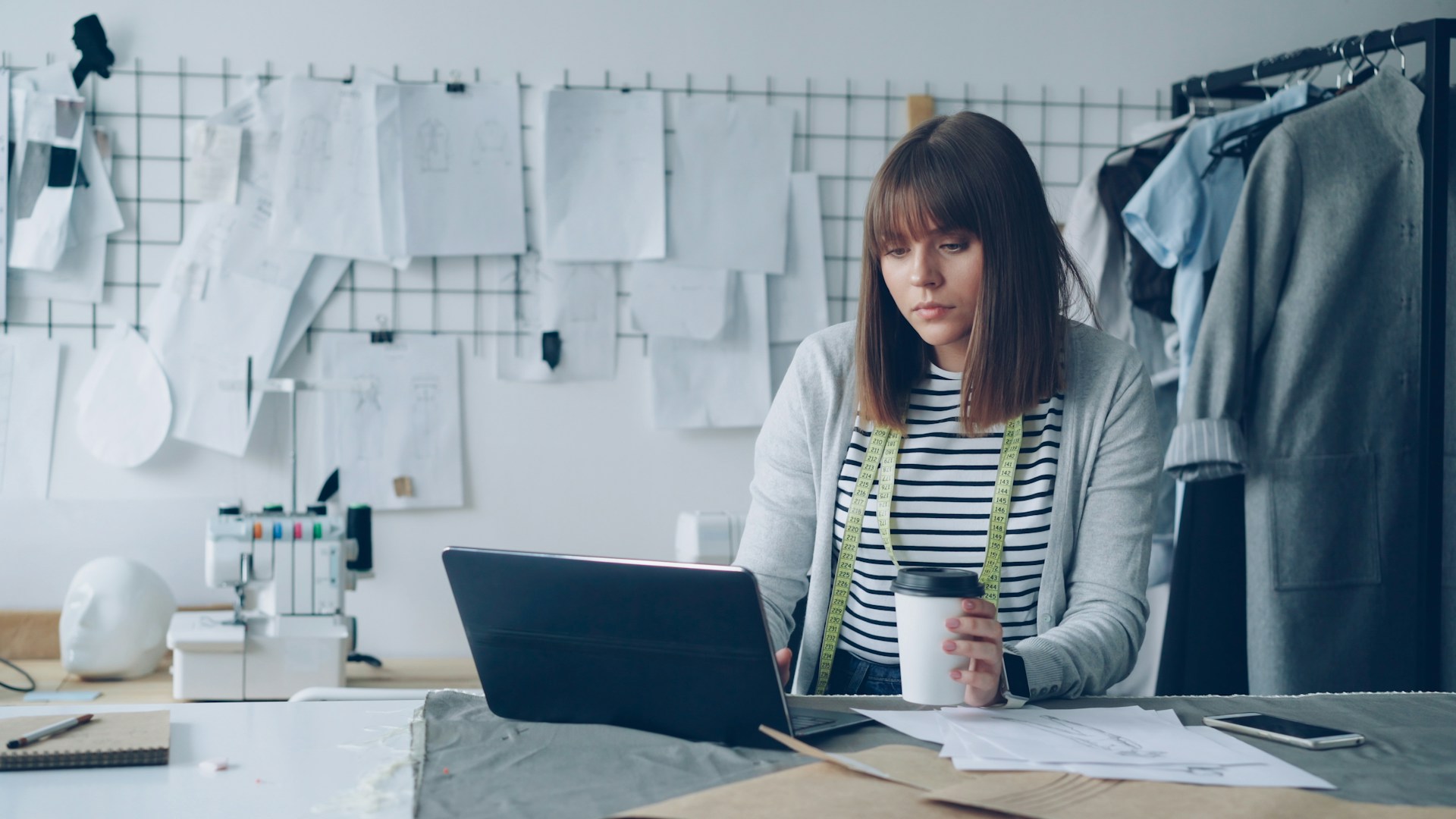 A young seamstress working on a laptop in a family-run business, representing shareholder oppression remedies in Vancouver, B.C. family companies
