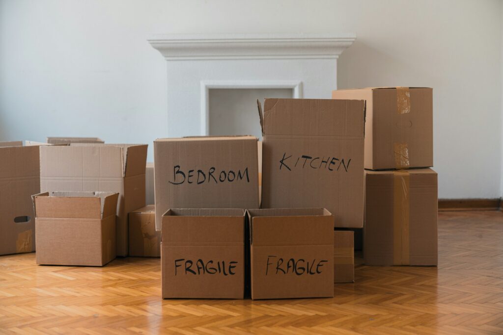 Stacks of moving boxes in an empty living room, representing relocation and mobility issues in BC family law disputes.